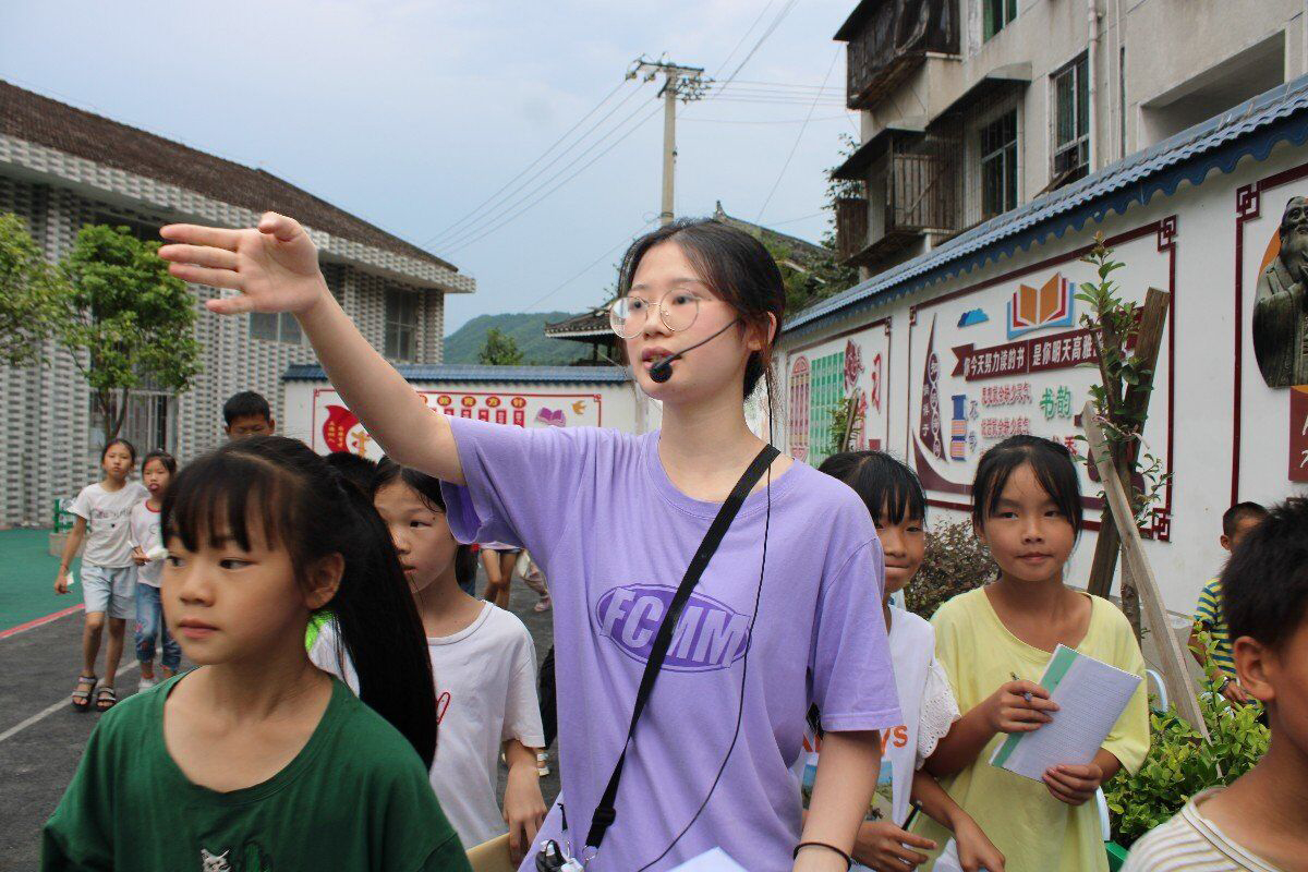 實(shí)踐隊(duì)隊(duì)員引導(dǎo)學(xué)生們認(rèn)識(shí)校園中的植物